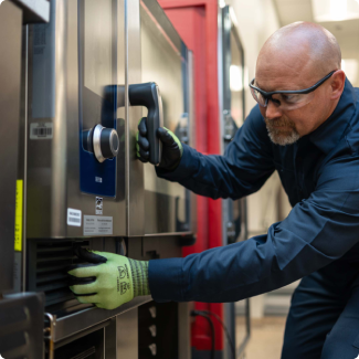 ESI technician opening a commercial combi oven to inspect its control panel